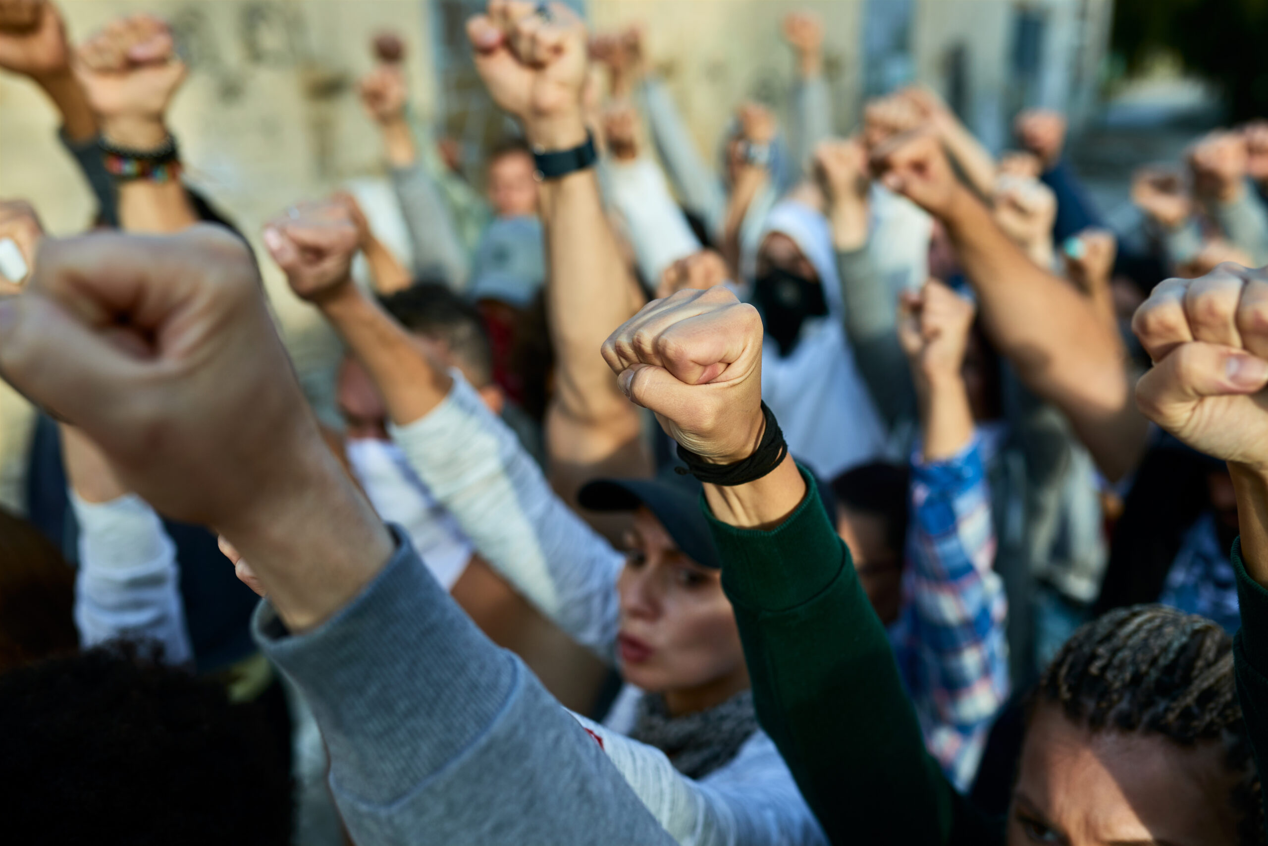 Close-up of large group of people with raised fists on public demonstrations.